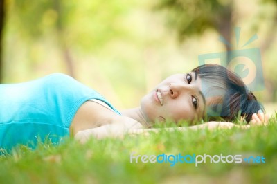 Young Lady Lying On Grass Stock Photo