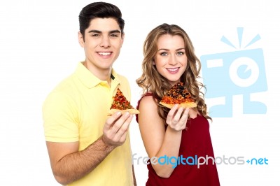 Young Lovers Posing With Pizza Slice In Hand Stock Photo