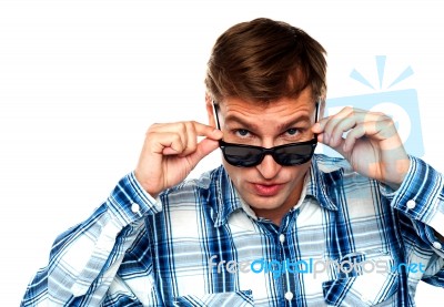 Young Man Adjusting Sunglasses Stock Photo