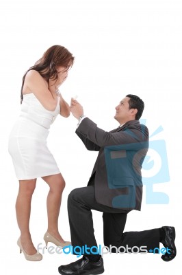 Young Man Down On His Knee Proposing To Girlfriend Stock Photo