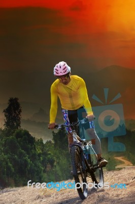 Young Man Riding Mountain Bike Bicycle Crossing Mountain Hill Ju… Stock Photo