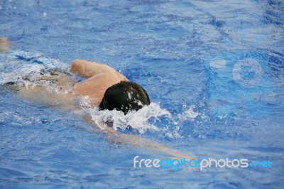 Young Man Swimming The Front Crawl In A Pool Stock Photo