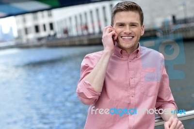 Young Man Using His Mobile Phone At Outdoors Stock Photo