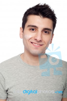 Young Man With Cream Lotion Stock Photo