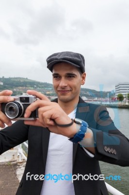 Young Man With Irish Beret Taking A Photo Stock Photo