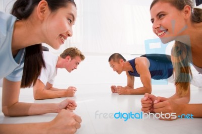 Young Multi Ethnic People Exercising In Gym Stock Photo