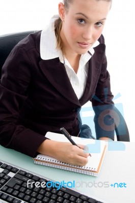 Young Professional Writing On Notebook Stock Photo