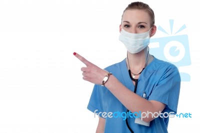Young Smiling Doctor Pointing Copy Space Stock Photo