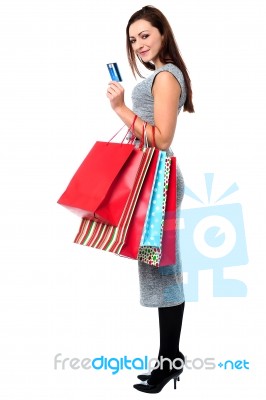 Young Woman Holding Shopping Bags And Credit Card Stock Photo