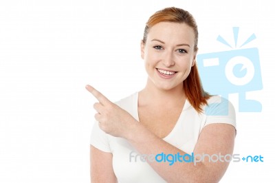 Young Woman Pointing Away Stock Photo