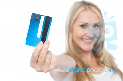 Young Woman Showing Credit Card To Camera Stock Photo