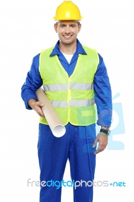 Young Worker Holding Blueprint Stock Photo