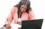 African girl writing with laptop Stock Photo