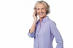 Aged Woman Attending Phone Call Stock Photo