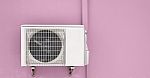Air Compressor On Pink Wall Stock Photo