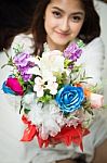 Asian Caucasian Giving Bouquet Of Colorful Flowers Stock Photo