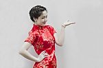 Asian Chinese Woman In Traditional Chinese Cheongsam Gesturing Stock Photo