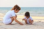 Asian Family Play Sand On Beach Stock Photo