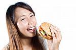 Asian Girl Eating Burger Stock Photo