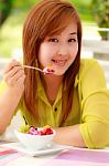 Asian Woman Eating Fruits Stock Photo
