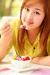 Asian Woman Eating Fruits Stock Photo