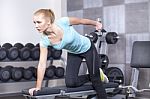 Attractive Blond Sporty Girl Doing Triceps Training With A Dumbb Stock Photo