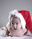 Baby Lying With Christmas Hat Stock Photo