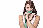 Beautiful Woman With Measuring Tape Wrapped On Face Stock Photo