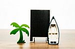 Blank Wooden Black Board With Green Palm Tree And White Boat Stock Photo