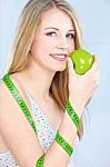 Blond Girl With Apple And Measuring Tape Stock Photo