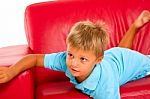 Boy On Red Sofa Stock Photo