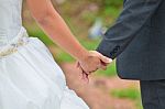 Bride And Groom Walking Away On The Road Stock Photo