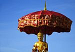 Buddha In The Red Umbrella Stock Photo