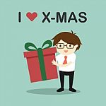 Business Concept, Businessman Holding A Gift Box With The Words "i Love X-mas" Stock Photo