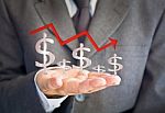 Business Man Showing Dollar Graph Stock Photo