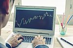 Businessman Analyze Stock Graph Or Forex Graph By Laptop On Blue Vintage Style Stock Photo