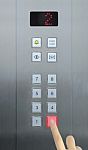 Businessman Hand Press 2 Floor In Elevator Stock Photo