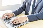 Businessman Typing Or Working With Laptop Or Notebook Stock Photo