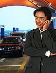 Businessman Waiting For A Taxi At The Airport Stock Photo