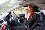 Businesswoman Drinking Coffee While Driving Stock Photo