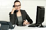 Businesswoman In Glasses Communicating On Phone Stock Photo