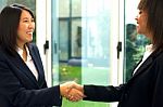 Businesswomen Shaking Hands Stock Photo
