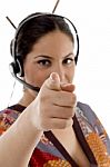Call Center Female Wearing Headphone Pointing At Camera Stock Photo