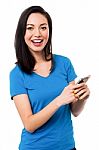 Casual Young Woman Using Smart Phone Stock Photo