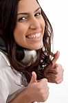 Caucasian Female Wearing Headphones And Gesturing Thumbs Up Stock Photo