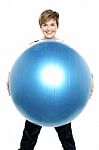 Charming Woman Holding Big Blue Fitness Ball Stock Photo