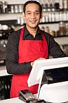 Cheerful Barista Staff At The Cash Counter Stock Photo