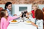 Cheerful Family Of Four Celebrating, Cheers! Stock Photo