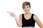 Cheerful Middle Aged Woman Pointing At Copy Space Area Stock Photo