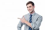 Cheerful Young  Man Pointing At Something Stock Photo